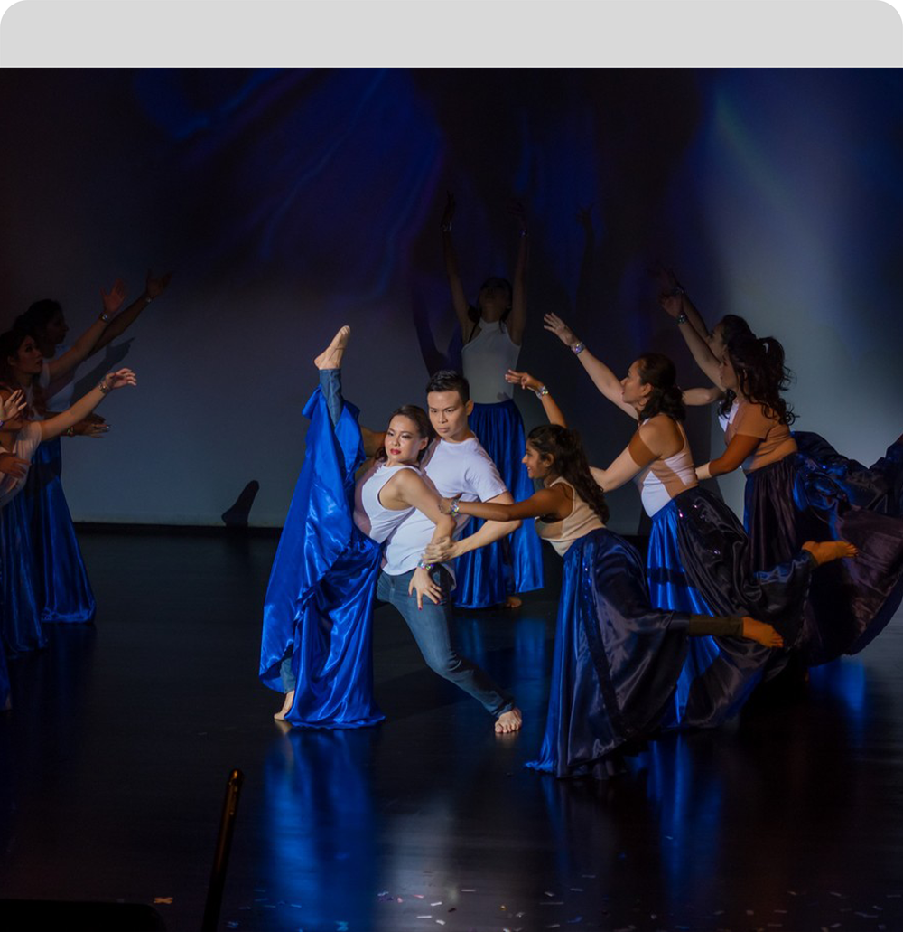 Dance performers on stage during a dramatic group performance